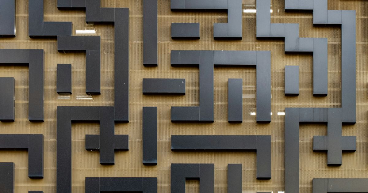 A textured wall featuring a striking pattern of alternating black and white squares, creating a bold visual contrast.